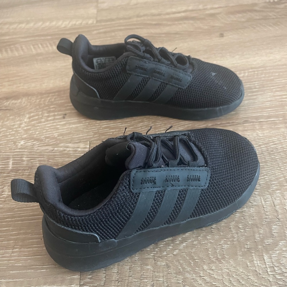 Boys black Adidas sneakers.